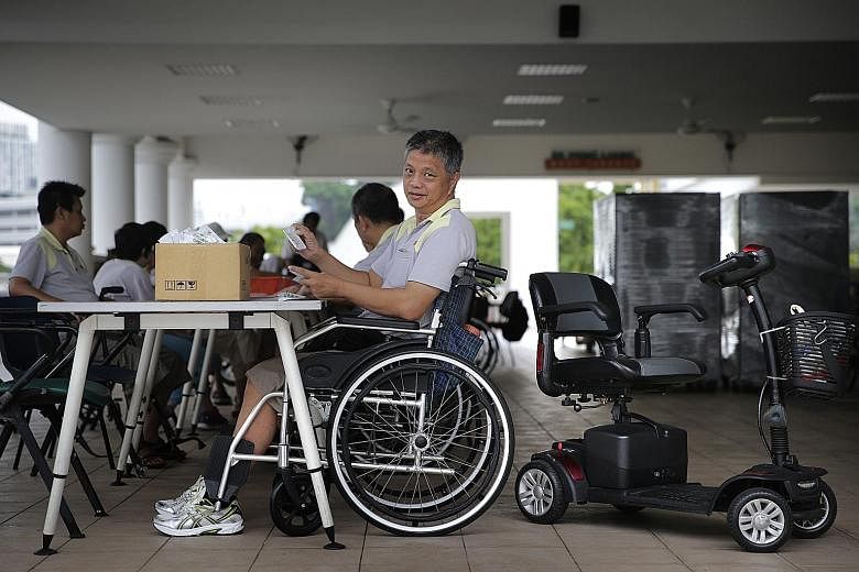SPD trainee Lim Tow Chong packing goodie bags. He goes to the workshop on a motorised scooter but transfers to a wheelchair for his job. Mr Lim is among a group of workers aged 18 to their 60s who have physical or development disabilities, or visual 