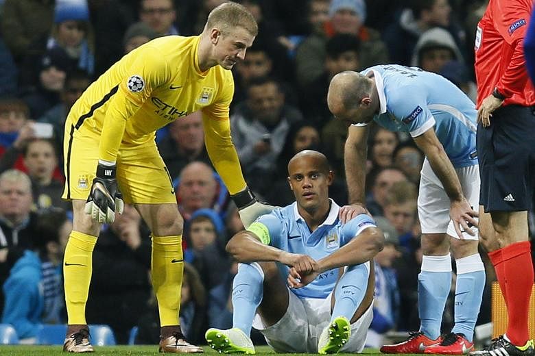 Manchester City's Joe Hart (left) and Pablo Zabaleta console their skipper Vincent Kompany after the Belgian suffered another injury to his calf, ruling him out for at least a month.
