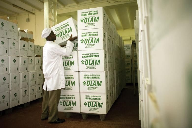 A worker moving boxes of cashew kernels at Olam International's Ivory Coast factory in West Africa. 