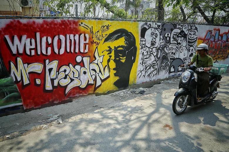 A wall with graffiti welcoming Myanmar's President-elect Htin Kyaw in Mandalay. A new civilian leadership, led by Ms Aung San Suu Kyi and Mr Htin Kyaw, will take office at the end of the month.
