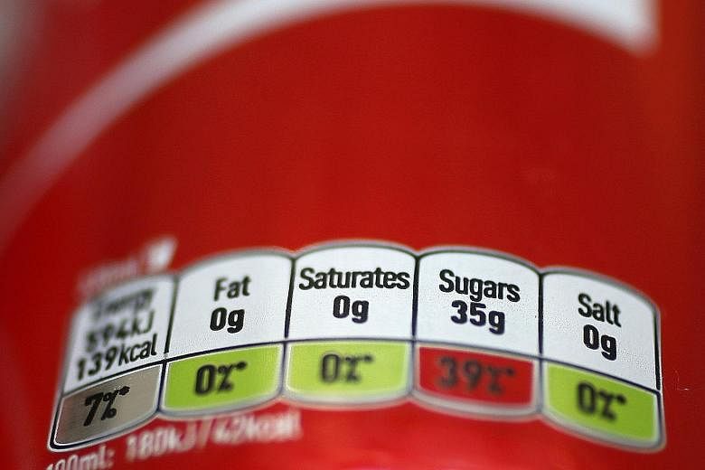Ingredients listed on a can of popular cola sold in Britain. The high sugar content in many soft drinks is helping to drive high rates of obesity.