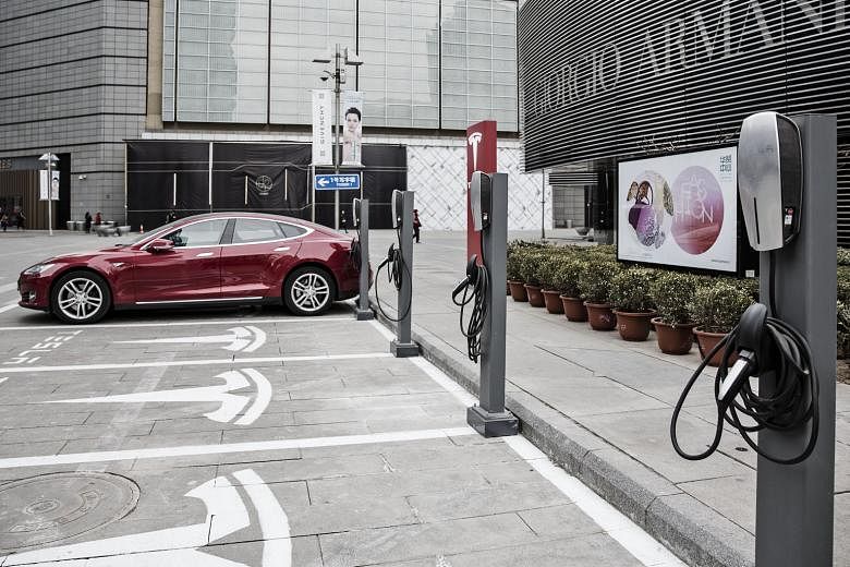 A Model S car parked at one of Tesla's charging stations in Beijing. In India and China, where power generation is heavily coal-based, electric vehicles have similar emissions as vehicles that use petrol. 