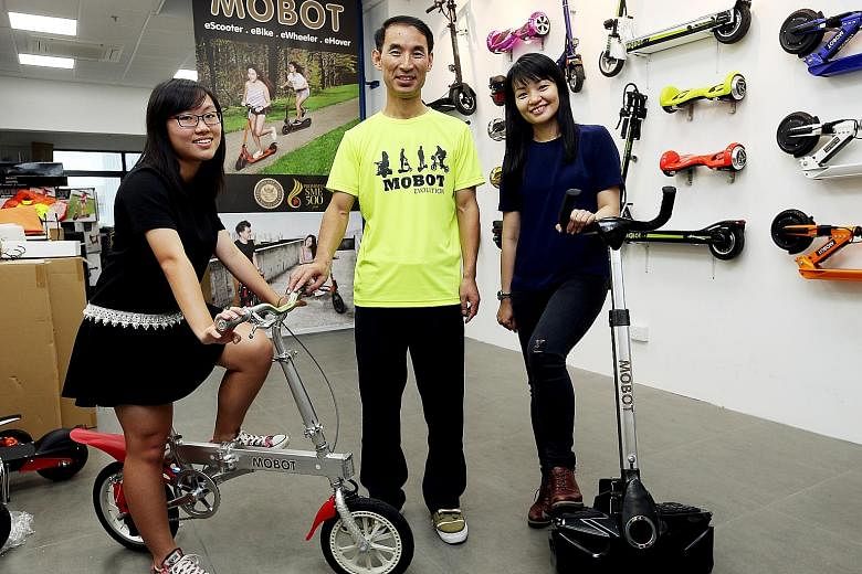 The latest winners of the ST Run giveaway - Ms Yolanda Constantine (right) and student Kuah Xiu Juan - with Mr Ifrey Lai, managing director of iZest, the distributor for Mobot. Ms Constantine and Xiu Juan won a Mobot glider and Mobot Kinetic eBike re