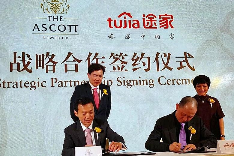 Mr Lim Ming Yan (left), CapitaLand president and group CEO, and Tujia co-founder Melissa Yang looking on as Mr Lee, Ascott CEO (seated left) and Mr Luo, Tujia CEO, signed their joint venture yesterday.