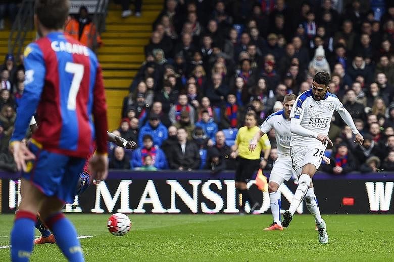 Leicester City winger Riyad Mahrez (right) sweeping home a superb pass from team-mate Jamie Vardy for his side's winner in their 1-0 victory over Crystal Palace at Selhurst Park yesterday. With the win, the Foxes opened up an eight-point gap between 