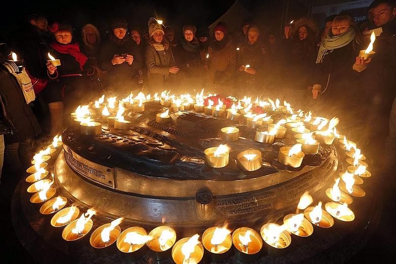 People lighting candles in central St Petersburg in memory of those who died when a Flydubai plane crashed during landing at the Rostov-on-Don airport in southern Russia, last Saturday. The Boeing 737-800 jet operated by the United Arab Emirates-base