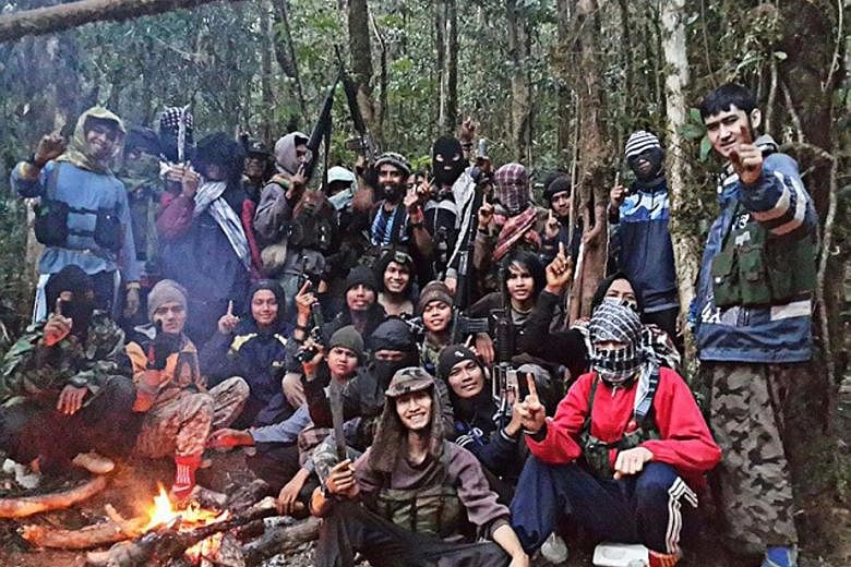 Members of the East Indonesia Mujahidin (MIT) terrorist group led by Indonesia's most-wanted man Santoso, whose real name is Abu Wardah, took a picture at their hiding place in the forests of Poso in Central Sulawesi. A loyalist of the Islamic State 