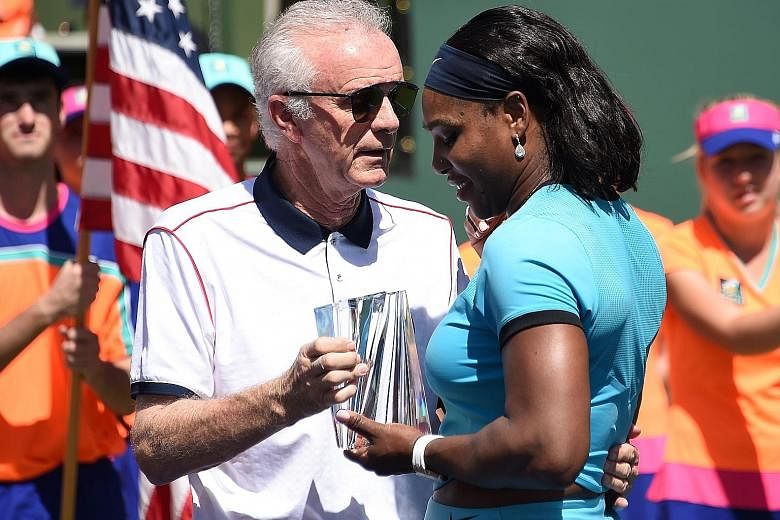 Raymond Moore presenting the runner-up trophy to Serena Williams after the women's final of the BNP Paribas Open at Indian Wells, where she lost to Victoria Azarenka 4-6, 4-6. Moore has since stepped down as chief executive and tournament director.