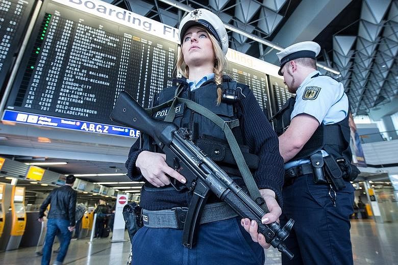 German police on patrol at the Frankfurt airport yesterday as Europe beefs up security at transport hubs and borders after the attacks.