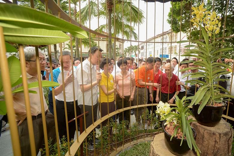 Admiring the Aranda Lee Kuan Yew and Vanda Kwa Geok Choo orchids at Tanjong Pagar Plaza's newly restored Orchid Pavilion at Saturday's remembrance event were (in front row, from left) former Tanjong Pagar GRC MP Koo Tsai Kee; Radin Mas MP Sam Tan; Tanjong