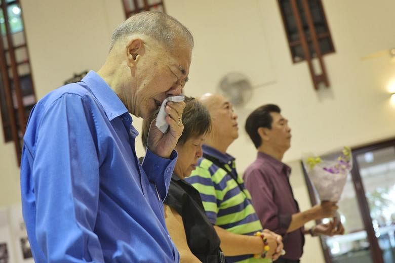 Retired calligrapher Seow Cheong Choon (in blue shirt) says time has helped him to overcome his grief. He was photographed last year with tears running down his face as he paid his respects to Mr Lee. 