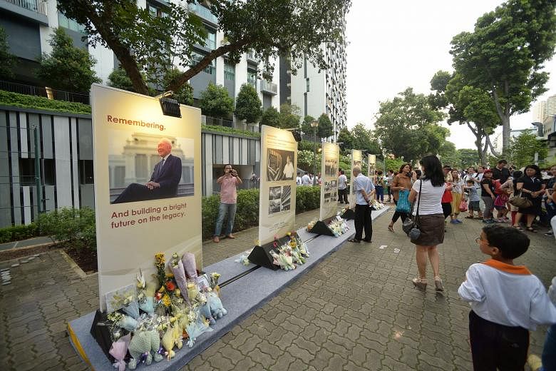 Members of the public paying tribute to Mr Lee at a Tanjong Pagar commemorative event, ahead of the first anniversary of his death today. Thousands of Singaporeans are setting time aside this week to remember Mr Lee's life and legacy as the leader of this
