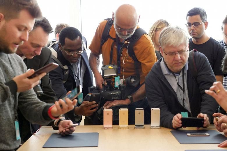 Members of the press taking photos and videos of the new 4-inch iPhone SE at Apple Campus Town Hall in Cupertino, US. The smartphone goes on sale in 12 markets, including Singapore, next week. 