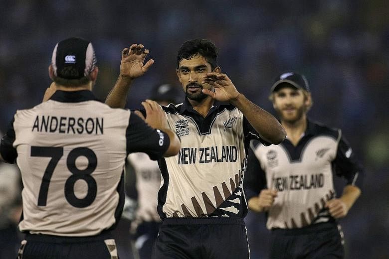 Ish Sodhi celebrating with Corey Anderson and other New Zealand team-mates after taking the vital wicket of Pakistan captain Shahid Afridi in their 22-run victory on Tuesday.