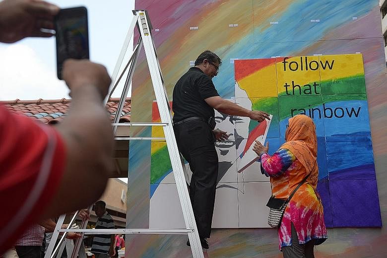 Artwork bearing Mr Lee Kuan Yew's image - done by Bedok residents and grassroots volunteers and citing his message to citizens to "follow that rainbow" and chart their own future - being put up on Sunday to mark the first anniversary of his death.
