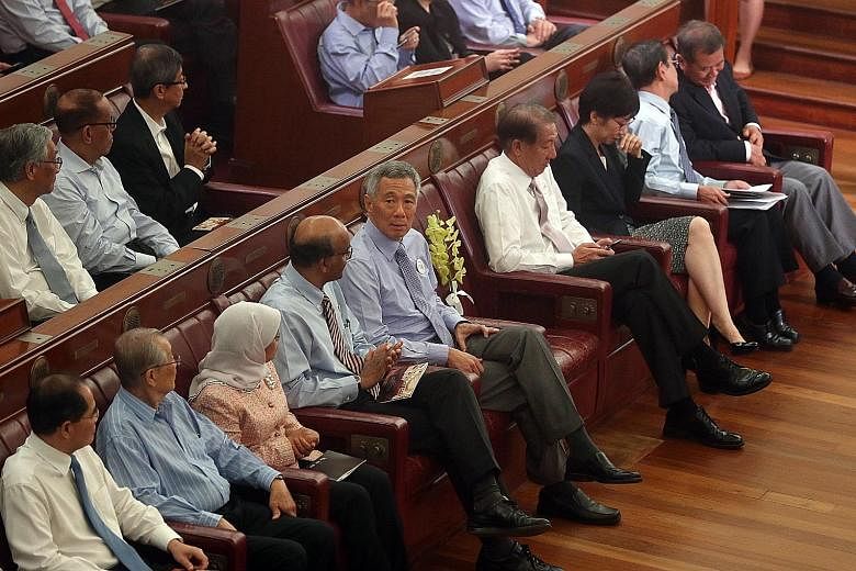 PM Lee with past and present parliamentarians at the Chamber of the Old Parliament House, now called The Arts House, yesterday, A spray of yellow hybrid orchids named Aranda Lee Kuan Yew was aptly placed on the seat Mr Lee had occupied - a bitterswee