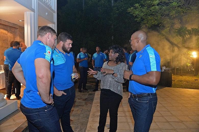 Members of the Bulls Super Rugby side with the High Commissioner of the Republic of South Africa, Hazel Francis Ngubeni, at a welcome function for the team at her residence yesterday. The Bulls play the Sunwolves tomorrow at the National Stadium.