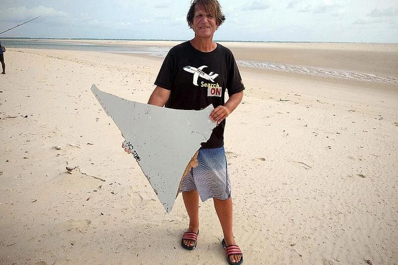 Mr Blaine Gibson, a 58-year-old lawyer from Seattle, with a piece of plane wreckage he found off the Mozambique coast last month. Malaysia's Transport Minister Liow Tiong Lai said a coastal search needs to be conducted around South Africa and Mozambi