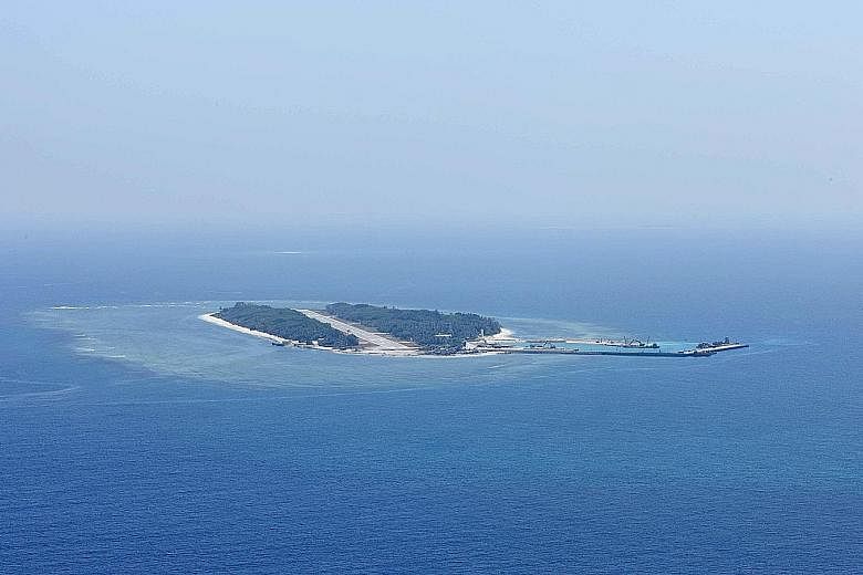 A Taiwanese coast guard (top) securing a military transport plane on Itu Aba (above), which the Taiwanese call Taiping.If the outcrop is considered an island, the Philippine's case will be out of the tribunal's jurisdiction.
