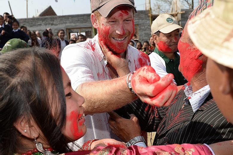 Britain's Prince Harry taking part in Holi, the Hindu festival of colours, while visiting the Gauda Secondary School in Okhari, in the foothills of the Himalayas, on Tuesday. The following day, the British royal, who was on an official six-day trip t
