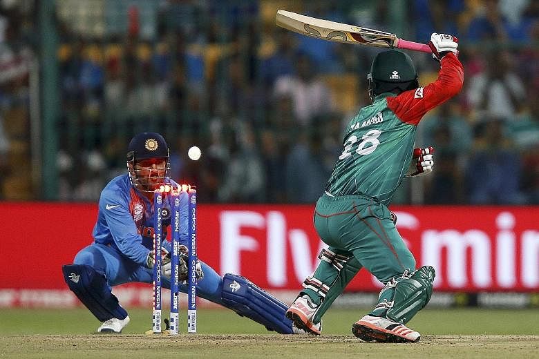 India captain Mahendra Singh Dhoni stumping Bangladesh opener Tamim Iqbal in their World Twenty20 Group 2 cricket match in Bangalore on Wednesday. He described his team's one-run win as being able to "manage chaos", but hosts India must beat Australi