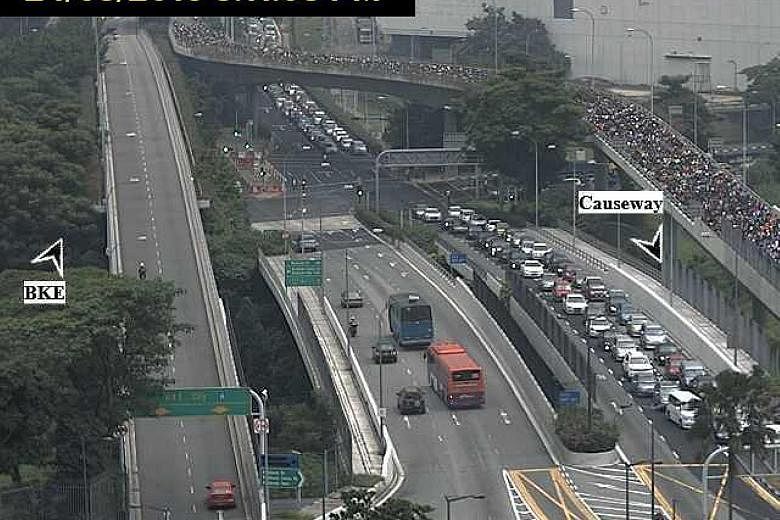 Traffic was already heavy at the Woodlands Checkpoint yesterday at around 5pm (above left) and the queues remained long as night fell.