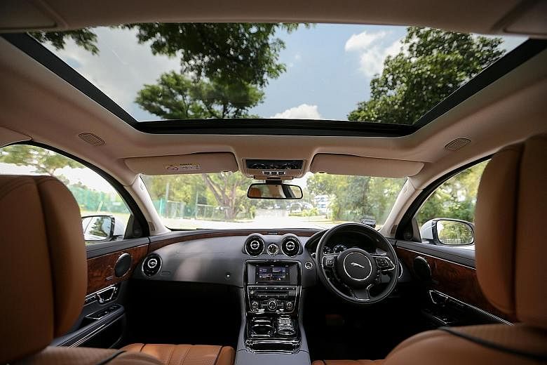 The Jaguar XJ 3.0 comes with a panoramic glass roof (above) and four-zone climate control that can be adjusted from the back seats (below).