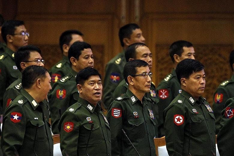 Military representatives at a Parliament session in Naypyitaw. The military has climbed down to allow Myanmar's experiment with democracy, but this will be a "firewalled" democracy.