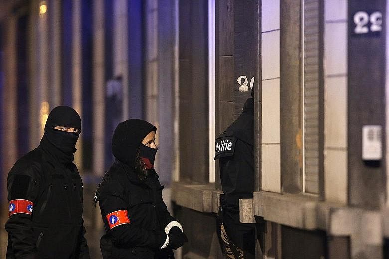 Police securing the entrance to a building in Schaerbeek during operations yesterday, following Tuesday's bomb attacks in Brussels. The operations came as France thwarted a deadly terrorist plot "at an advanced stage" with the arrest of a man in the 