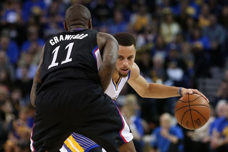 Golden State's Stephen Curry taking on Los Angeles Clippers' Jamal Crawford in Oakland on Wednesday. The Warriors' 114-98 win was their 51st consecutive regular-season home victory and improved their mark to 64-7. 