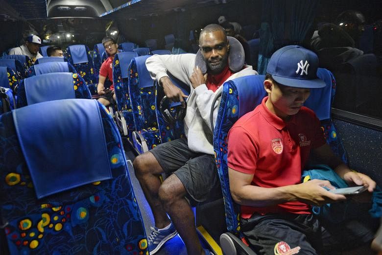 Justin Howard and Wong Wei Long making themselves comfortable yesterday before the team bus left for Woodlands Checkpoint en route to Kuala Lumpur for Game Five of the ABL Finals. 