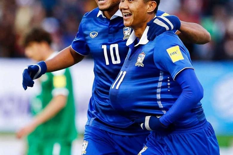 Thailand's Mongkol Thosakrai (right) celebrating the opener with Teerasil Dangda in the World Cup qualifier against Iraq that ended 2-2 in Teheran on Thursday. 