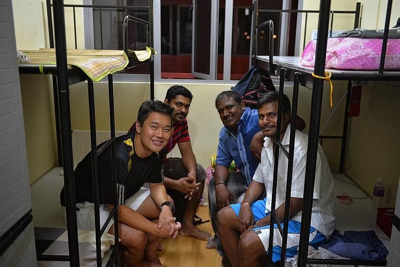 Left: ST reporter Aw Cheng Wei with his three roommates at Woodlands Westlite, where he spent three nights earlier this month. Workers typically sleep on double-decker beds with plywood boards. Workers frequent this supermarket stocked with items fro