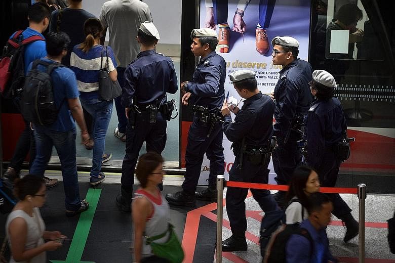 Since the Brussels attacks, patrols have been stepped up at key installations like transport nodes, including Changi Airport (above) and MRT stations (below). Security experts have suggested measures like setting up random checkpoints as a "visual de