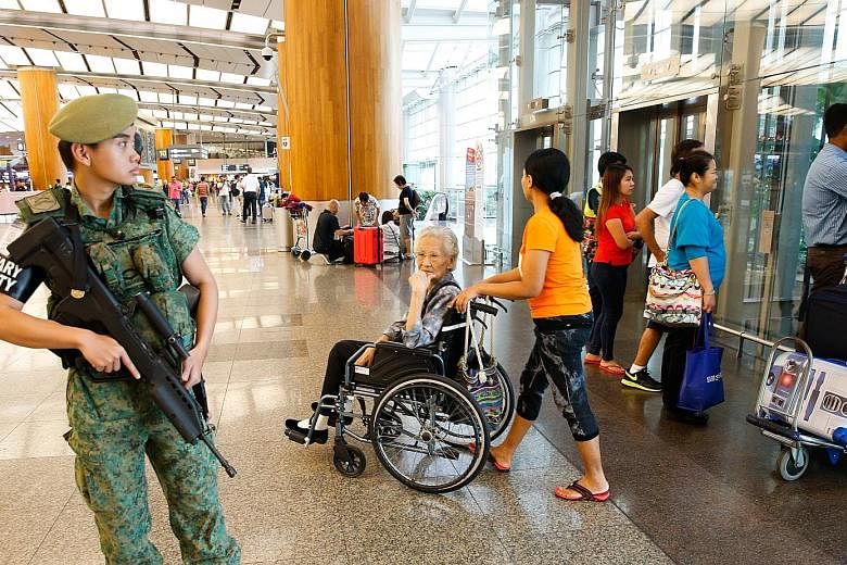 Since the Brussels attacks, patrols have been stepped up at key installations like transport nodes, including Changi Airport (above) and MRT stations (below). Security experts have suggested measures like setting up random checkpoints as a "visual de