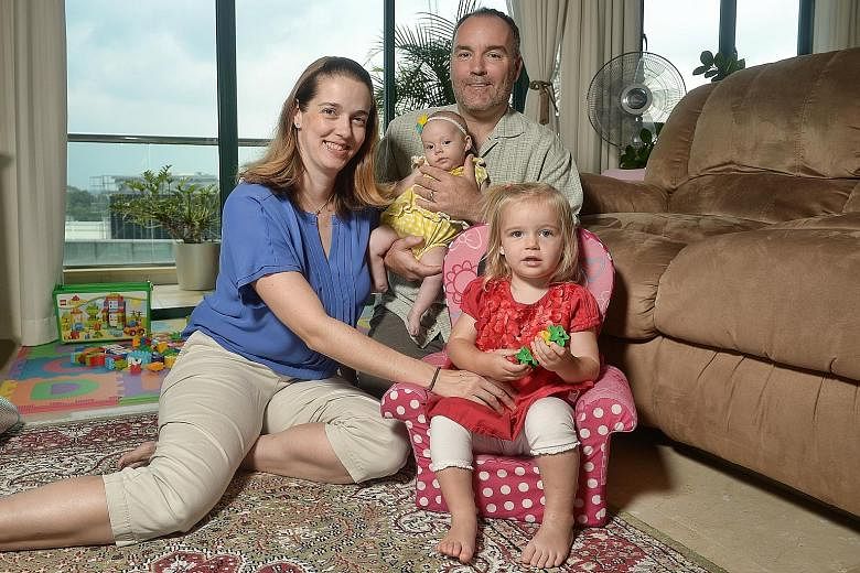 Mr Letzelter with his wife Jennifer and their daughters, three-month-old Lucy and 23-month-old Olivia. The couple find that it helps to stock up on clothes in the US during their visits home, as they can cost less there.