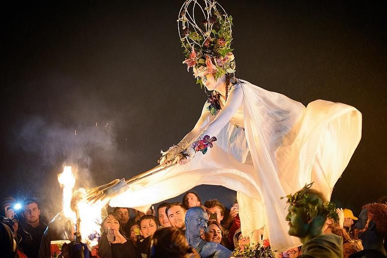 Land dives at Pentecost Island in Vanuatu (left) and the May Queen (above) at the annual Beltane Fire Festival in Edinburgh, Scotland.