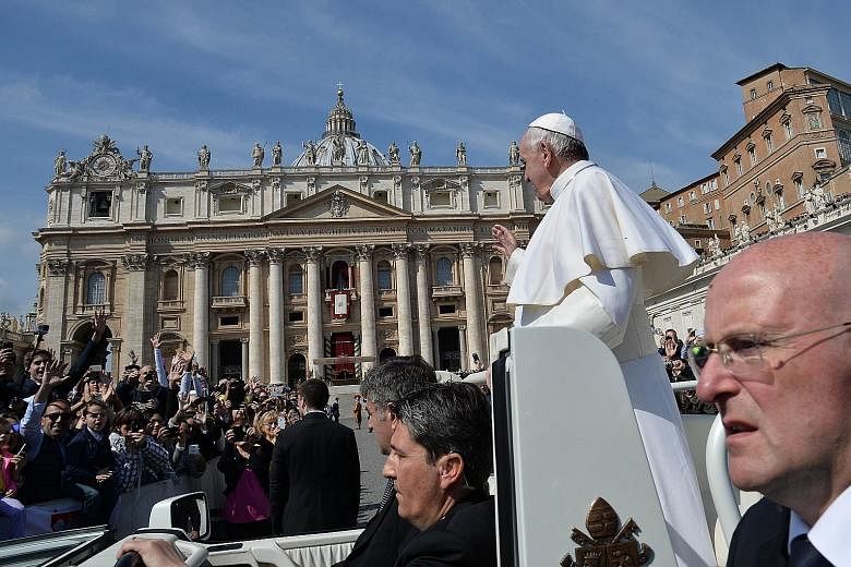 Pope Francis greeting the crowd from the popemobile after the Easter Sunday Mass in St Peter's Square yesterday.
