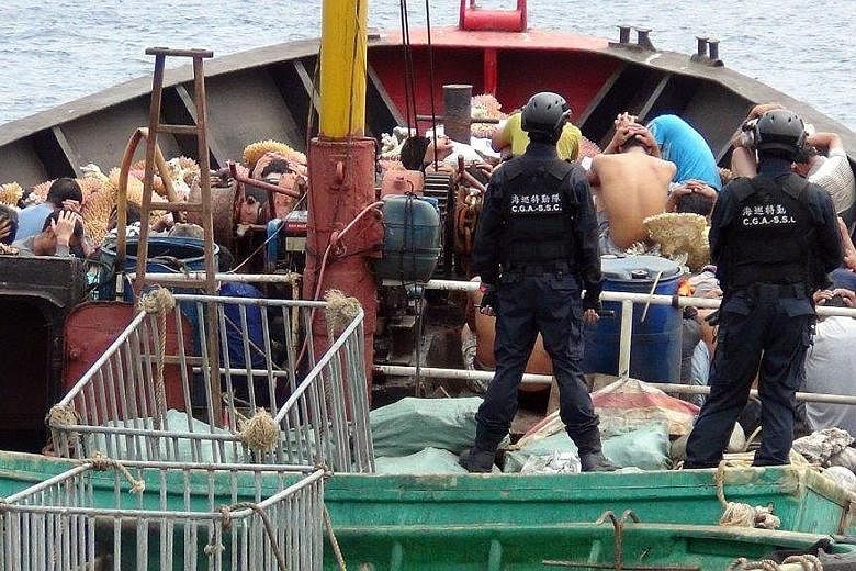 The Chinese fishing boat and its crew being detained on March 22 for illegally harvesting coral and endangered turtles in waters near a disputed atoll in the South China Sea.
