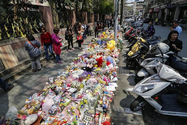 A makeshift memorial site of flowers and soft toys for the girl who was killed on Monday, near where she was attacked, on the outskirts of Taipei. The attacker had followed the girl and her mother for an hour before killing her with a kitchen knife.
