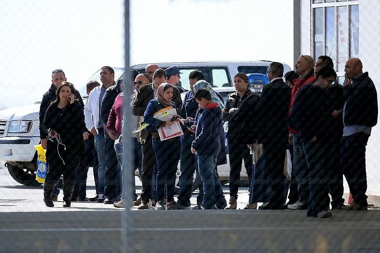 Passengers at Larnaca airport after disembarking from the aircraft. Those on board included 21 foreigners. Some reports described the hijacker as a former Egyptian army officer who lived in Cyprus up to 1994. A man (far right) believed to be the hija