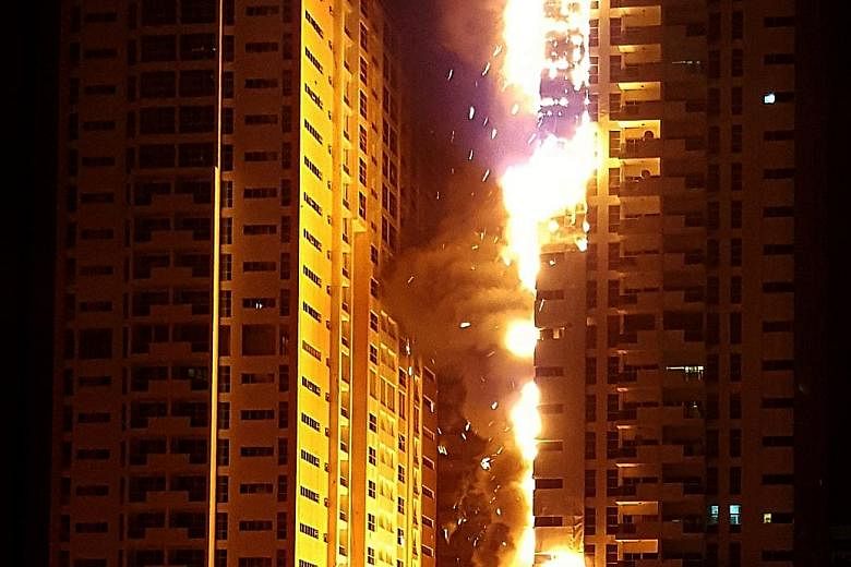 A fire broke out in a building in Ajman One, a residential cluster of 12 towers in the United Arab Emirates, on Monday. Five people were treated for injuries. The fire gutted at least two towers in the fourth major high-rise fire in the UAE in three 