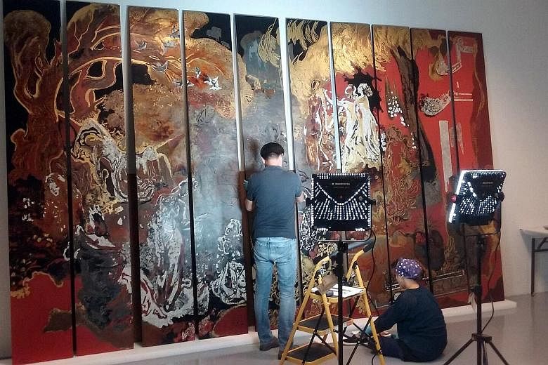 Conservators checking Nguyen Gia Tri's The Fairies (above), one of the works in Reframing Modernism (below), a new exhibition at the National Gallery Singapore.