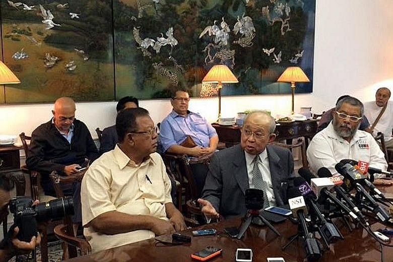Tengku Razaleigh (front row, centre) meeting the media at his home yesterday. The MP, who is respected by both the opposition and ruling party, faced criticism after declaring his support for Mr Najib.