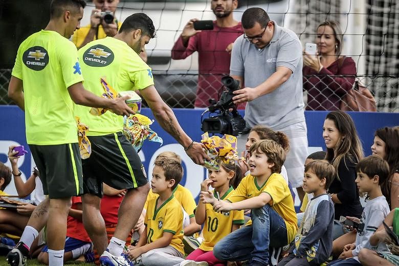 Brazil coach Dunga will hope his players, seen here giving out chocolate Easter gifts after training, will be less charitable when they play in Paraguay. In their last qualifier, Brazil let slip a two-goal lead to allow Uruguay to come back and draw 2-2. 