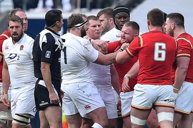 England's Joe Marler (with headband) clashes with Wales' Samson Lee during the Six Nations match at Twickenham.