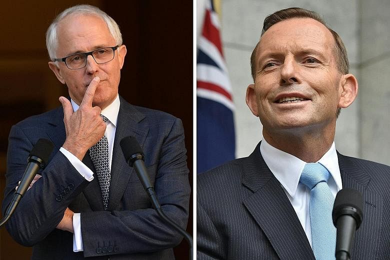 Some observers have suggested that Mr Turnbull (top) offer his rival, Mr Abbott (above), a senior job to neutralise him before the elections.