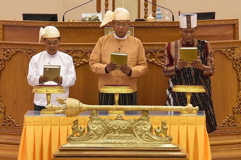 Myanmar's President Htin Kyaw (centre) flanked by his Vice-Presidents Myint Swe (left) and Henry Van Thio at yesterday's swearing-in ceremony.