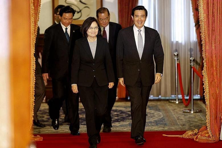 Taiwanese President-elect Tsai Ing-wen with outgoing President Ma Ying-jeou in Taipei yesterday - their first meeting since Ms Tsai and the DPP swept to victory in the Jan 16 elections. Both leaders struck a conciliatory note, with the KMT's Mr Ma sa