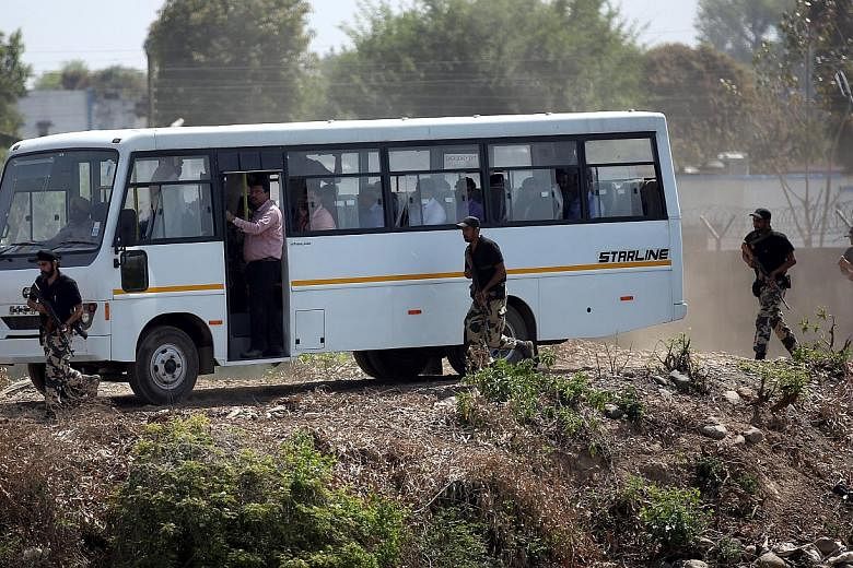 Members of a Pakistani security team accompanied by Indian officials in a bus on their way to the scene of the Jan 2 militant attack at the Indian Air Force base in Pathankot, India, on Tuesday.